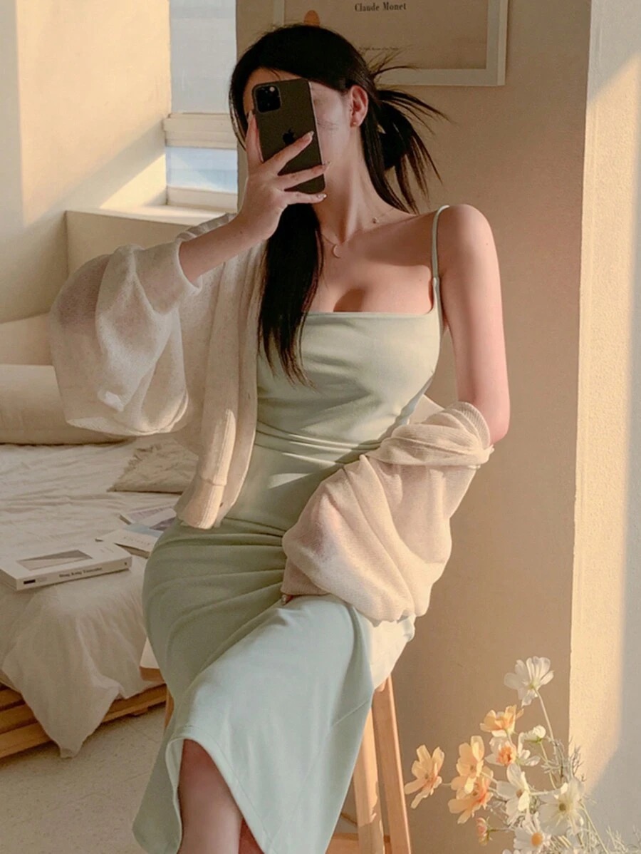 Woman wearing light green slip dress and ivory cardigan