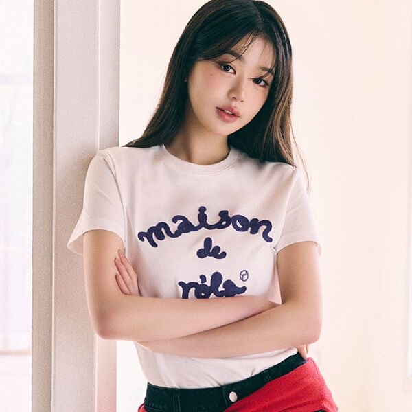 Woman wearing a white lettering t-shirt posing confidently