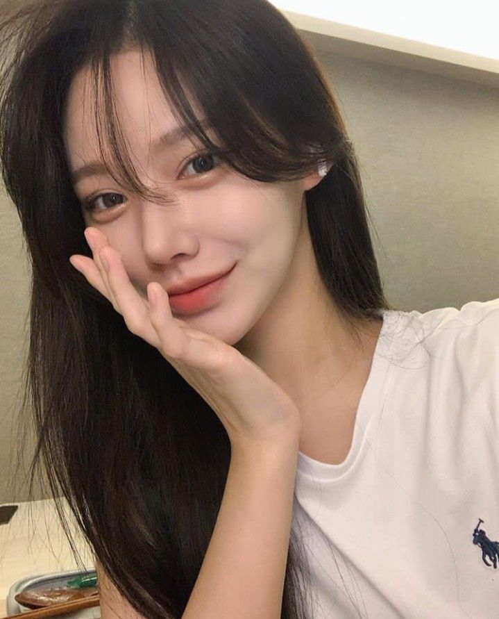 Woman with bangs and sleek long straight layered hair