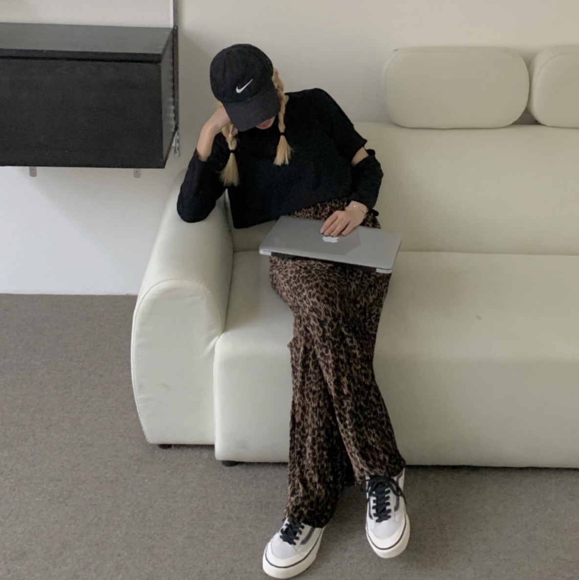 Woman in street outfit with Nike cap and leopard print pants