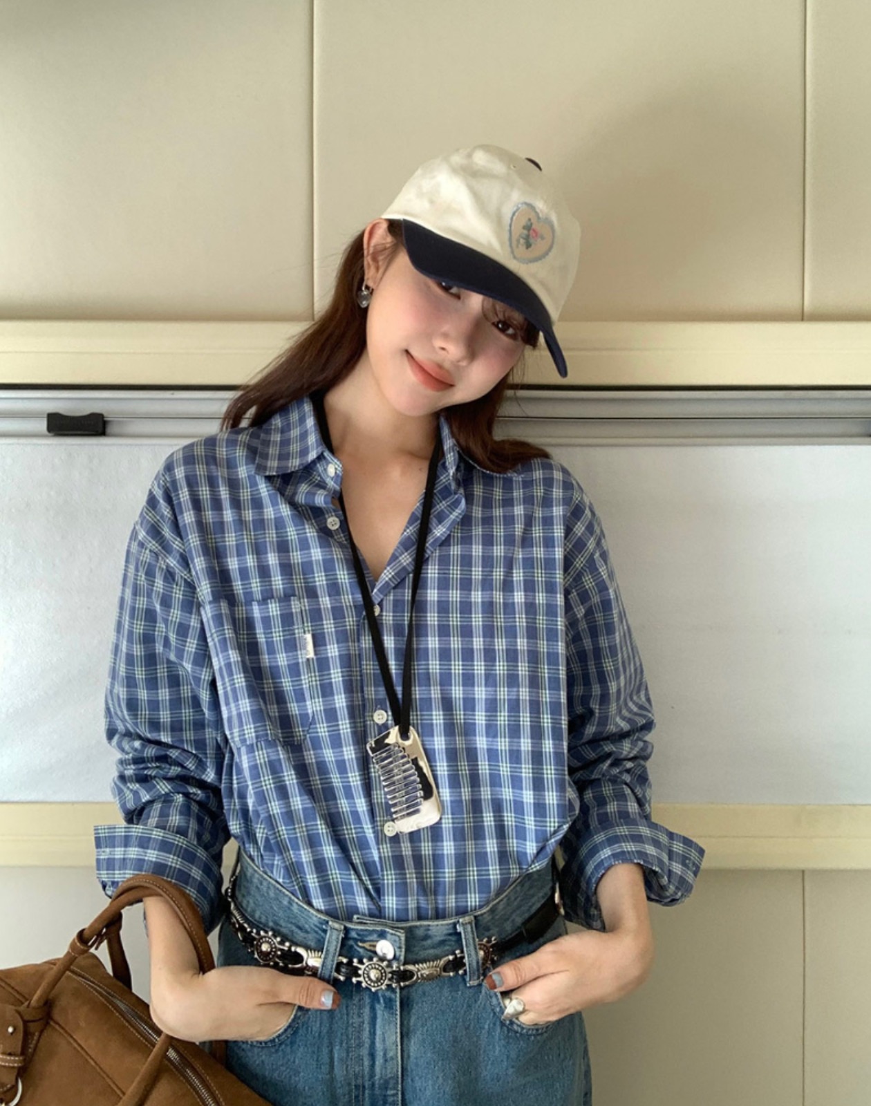 Woman in a vintage fashion outfit with check shirt and wide denim